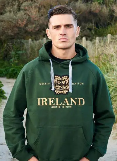 Dark haired man outside wearing green Celtic hoodie